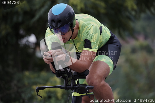 Image of triathlon athlete riding a bike on morning training