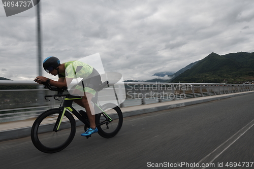 Image of triathlon athlete riding a bike on morning training