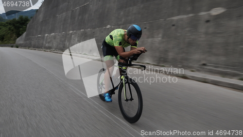 Image of triathlon athlete riding a bike on morning training