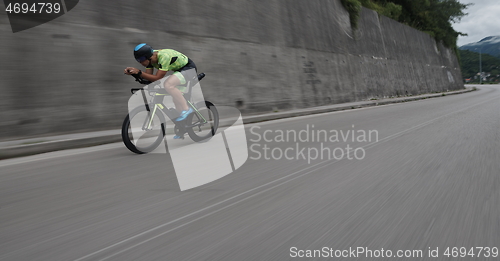 Image of triathlon athlete riding a bike on morning training