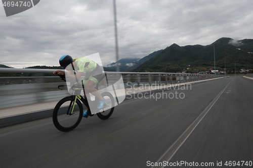 Image of triathlon athlete riding a bike on morning training