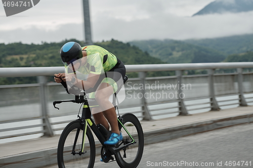 Image of triathlon athlete riding a bike on morning training