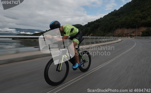 Image of triathlon athlete riding a bike on morning training