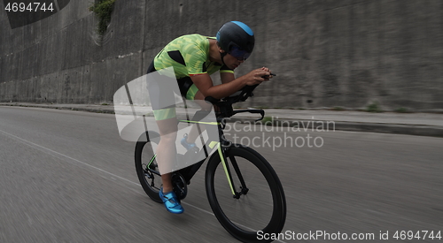 Image of triathlon athlete riding a bike on morning training