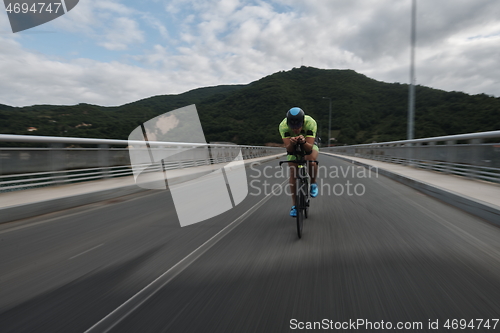 Image of triathlon athlete riding a bike on morning training