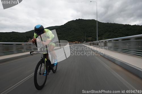 Image of triathlon athlete riding a bike on morning training