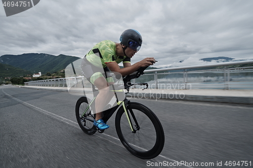 Image of triathlon athlete riding a bike on morning training