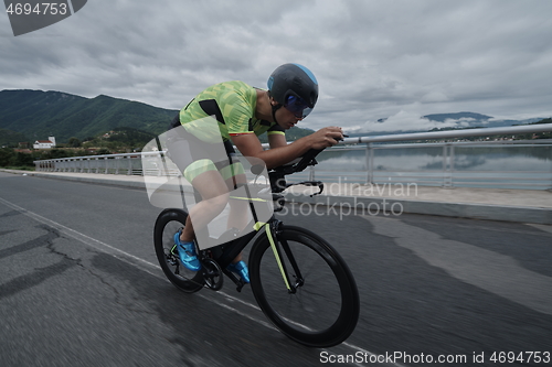 Image of triathlon athlete riding a bike on morning training