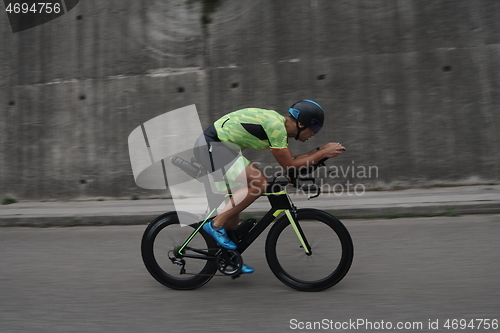 Image of triathlon athlete riding a bike on morning training