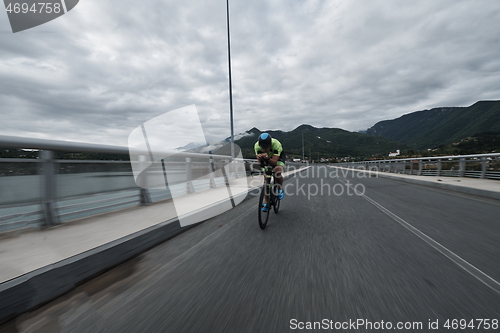 Image of triathlon athlete riding a bike on morning training