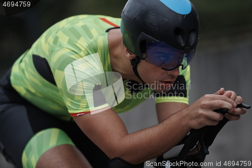 Image of triathlon athlete riding a bike on morning training