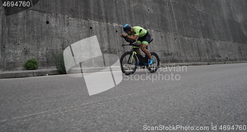 Image of triathlon athlete riding a bike on morning training