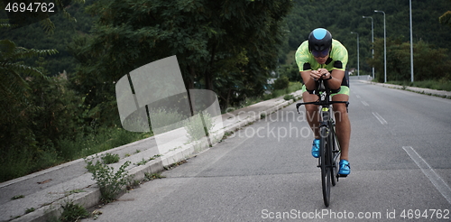 Image of triathlon athlete riding a bike on morning training