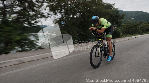 Image of triathlon athlete riding a bike on morning training