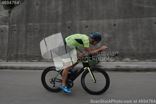 Image of triathlon athlete riding a bike on morning training