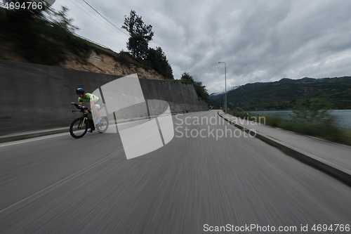 Image of triathlon athlete riding a bike on morning training