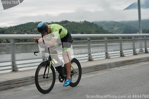 Image of triathlon athlete riding a bike on morning training