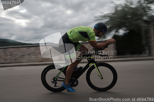 Image of triathlon athlete riding a bike on morning training