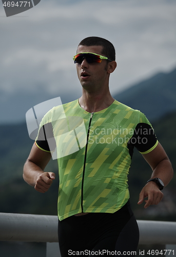 Image of triathlon athlete running on street