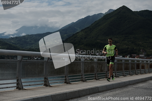 Image of triathlon athlete running on street