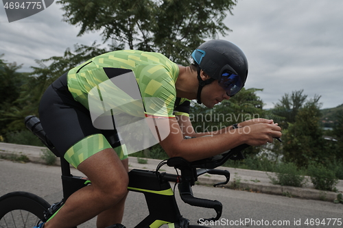 Image of triathlon athlete riding a bike on morning training