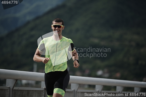 Image of triathlon athlete running on street