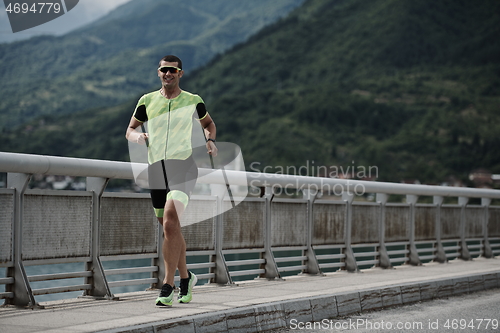 Image of triathlon athlete running on street