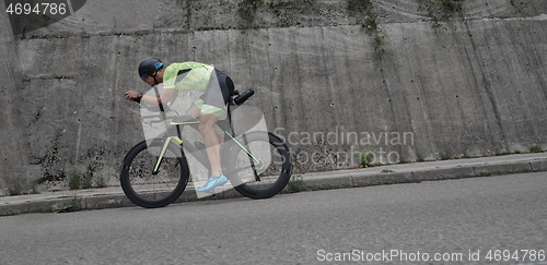 Image of triathlon athlete riding a bike on morning training