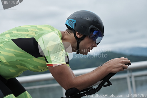 Image of triathlon athlete riding a bike on morning training