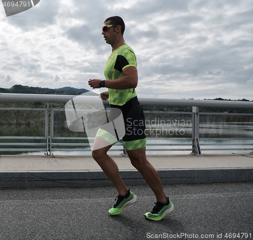 Image of triathlon athlete running on street