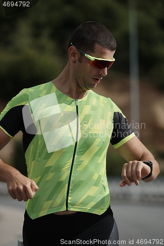 Image of triathlon athlete running on street