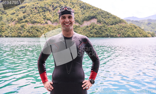 Image of triathlete swimmer portrait wearing wetsuit on training