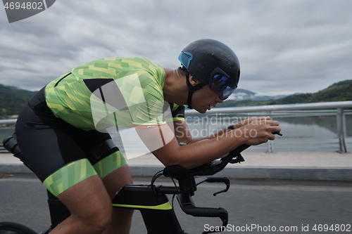 Image of triathlon athlete riding a bike on morning training