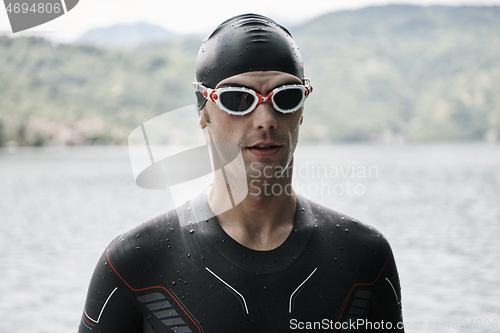 Image of triathlete swimmer portrait wearing wetsuit on training