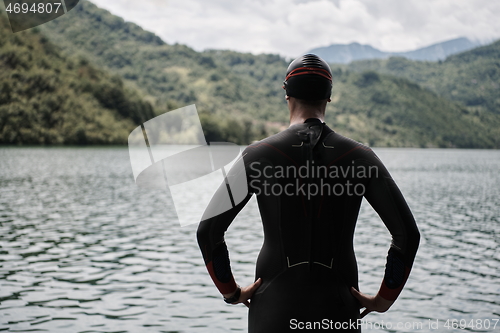 Image of triathlete swimmer portrait wearing wetsuit on training