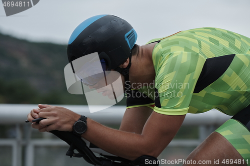 Image of triathlon athlete riding a bike on morning training