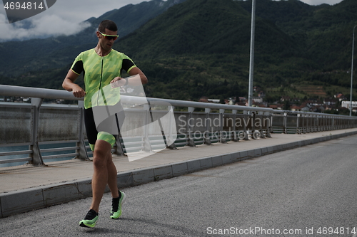 Image of triathlon athlete running on street