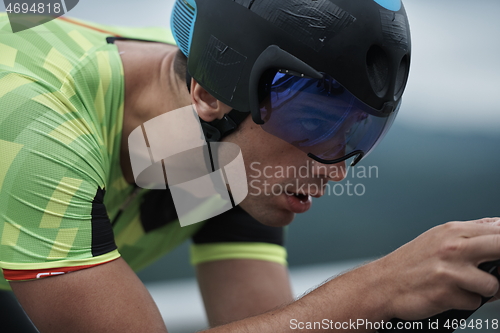 Image of triathlon athlete riding a bike on morning training