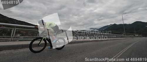 Image of triathlon athlete riding a bike on morning training