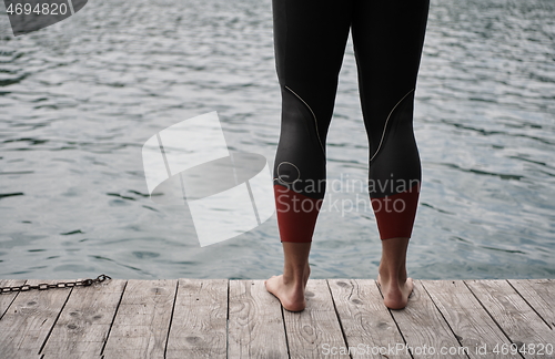 Image of triathlete swimmer portrait wearing wetsuit on training