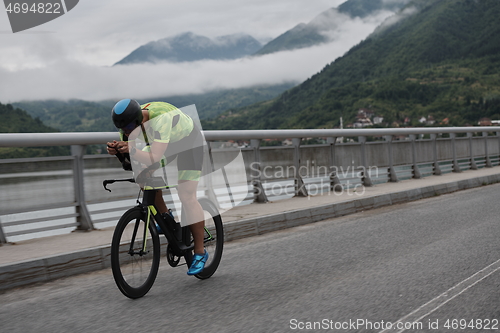 Image of triathlon athlete riding a bike on morning training