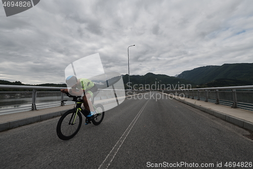 Image of triathlon athlete riding a bike on morning training