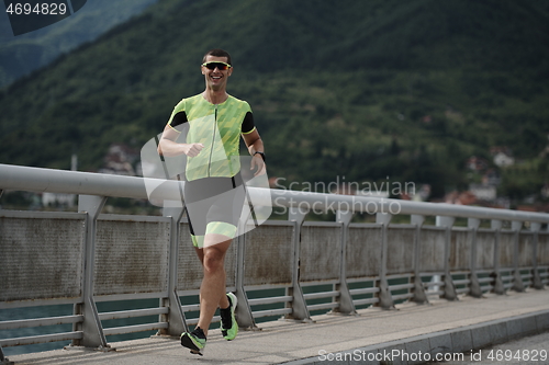 Image of triathlon athlete running on street