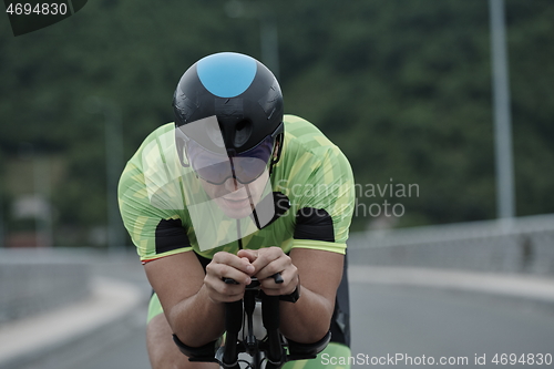 Image of triathlon athlete riding a bike on morning training