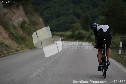 Image of triathlon athlete riding a bike wearing black