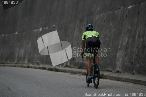 Image of triathlon athlete riding a bike on morning training