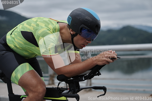 Image of triathlon athlete riding a bike on morning training