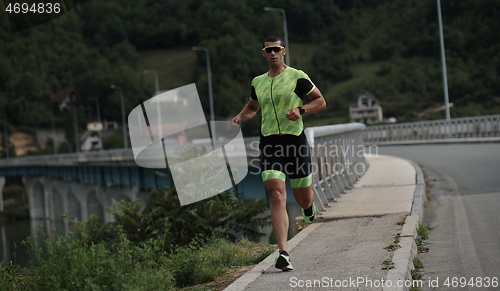 Image of triathlon athlete running on street