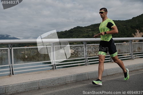 Image of triathlon athlete running on street