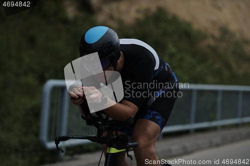 Image of triathlon athlete riding a bike wearing black